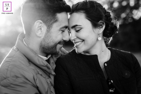 In France, a photographer took a close-up picture of a couple in black and white, smiling while touching noses during their photo session.
